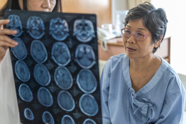 Patient looks at X-Ray of brain scans