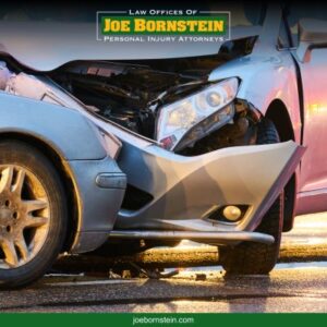 Two damaged cars on the road after a collision at dusk in Augusta, ME 
