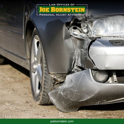 The front bumper of a car smashed in after a car accident in Sanford, Maine