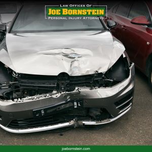A grey car with severe front end damage after an accident in Lewiston