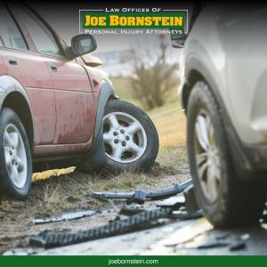 A car with a broken wheel sits on the side of the road after a car accident in Sanford 