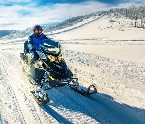 Maine snowmobile rider in snow